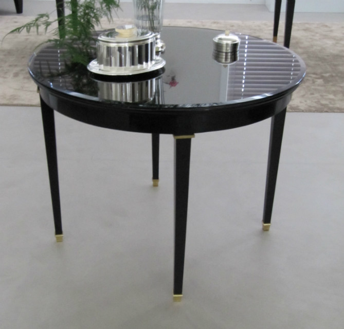 A round 1950s ebonised table