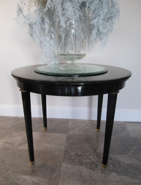 A round 1950s ebonised table